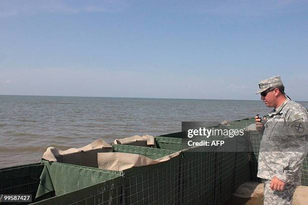 National Guard captain Matt Terry reviews on May 14 baskets that are being set up on the shore of Dauphin Island, a bird sanctuary in Alabama. The US...
