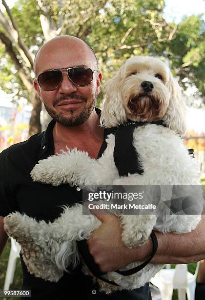 Fashion designer Alex Perry poses with his dog after completing the RSPCA Million Paws Walk at Sydney Olympic Park on May 16, 2010 in Sydney,...