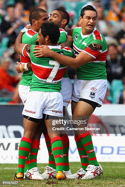 Nathan Merritt of the Rabbitohs celebrates a try with team mates during the round ten NRL match between the Wests Tigers and the South Sydney...