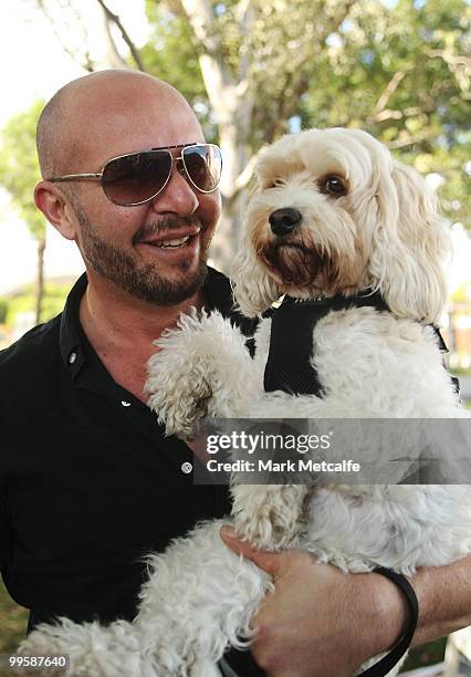 Fashion designer Alex Perry poses with his dog after completing the RSPCA Million Paws Walk at Sydney Olympic Park on May 16, 2010 in Sydney,...