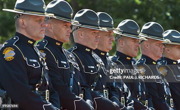 Members of the Kentucky State Police Honor Guard stand their position on a long line of police officers from various US states as US President Barack...