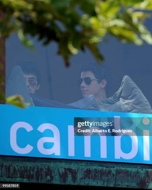 Musician Joe Jonas and musician Nick Jonas wait to perform live at the Grove to kick off the summer concert series on May 15, 2010 in Los Angeles,...