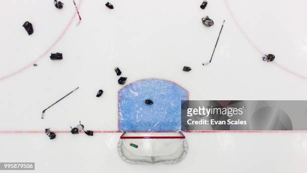 hockey sticks and helmets on an ice hockey rink. - ice hockey stockfoto's en -beelden