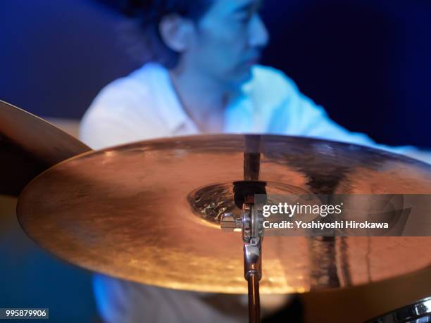 senior man playing drum set on recording studio - chofu stock-fotos und bilder