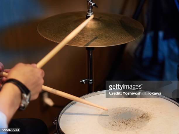 cose up of senior man playing drum set on recording studio - chofu stock-fotos und bilder