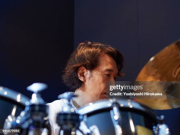 senior man playing drum set on recording studio - chofu stock-fotos und bilder