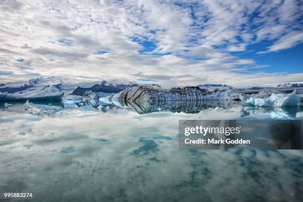 recently calved icebergs floating in a lagoon in south east iceland. - south east iceland stock pictures, royalty-free photos & images