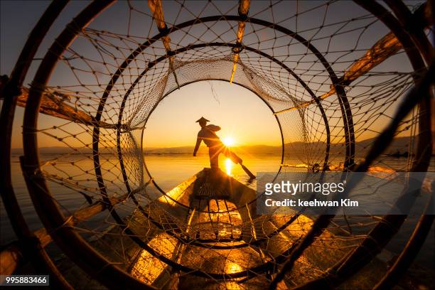 a fisherman at sunset on inle lake, myanmar. - images 個照片及圖片檔