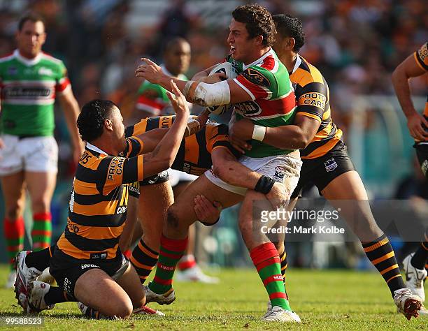 Sam Burgess of the Rabbitohs is tackled during the round ten NRL match between the Wests Tigers and the South Sydney Rabbitohs at Sydney Cricket...