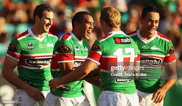 Fetuli Talanoa of the Rabbitohs celebrates with his team mates after scoring a try during the round ten NRL match between the Wests Tigers and the...