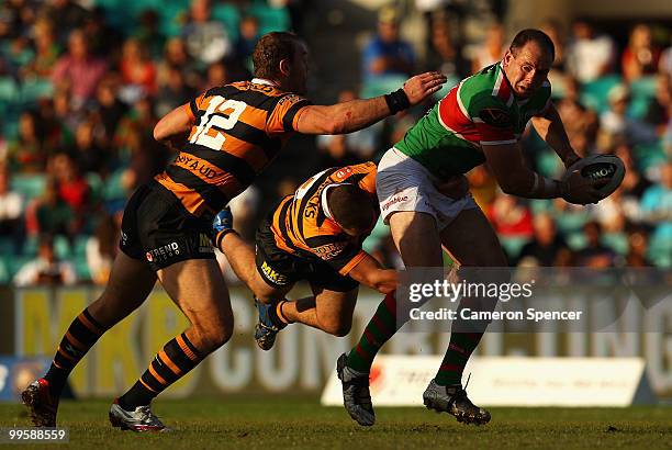 Luke Stuart of the Rabbitohs is tackled during the round ten NRL match between the Wests Tigers and the South Sydney Rabbitohs at Sydney Cricket...