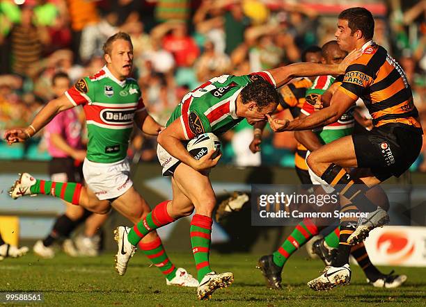 Ben Lowe of the Rabbitohs is tackled during the round ten NRL match between the Wests Tigers and the South Sydney Rabbitohs at Sydney Cricket Ground...