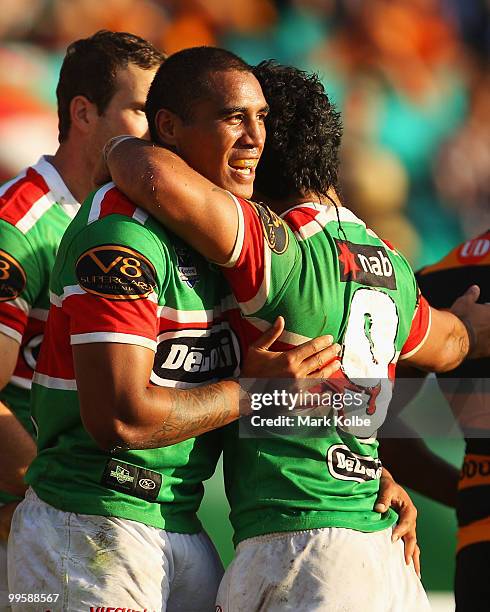 Fetuli Talanoa of the Rabbitohs celebrates with his team mates after scoring a try during the round ten NRL match between the Wests Tigers and the...