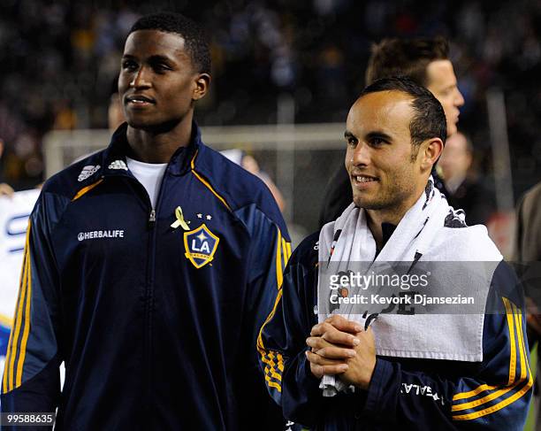 Edson Buddle and Landon Donovan of the Los Angeles Galaxy look at the stadium screen during a World Cup send off ceremony after their MLS soccer...