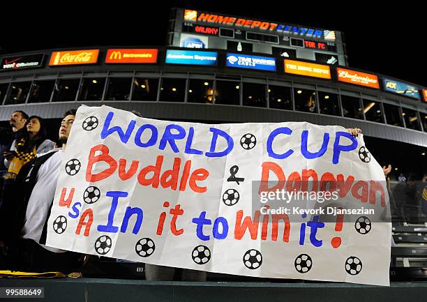 Fans hold signs during a World Cup send off ceremony for Edson Buddle and Landon Donovan of the Los Angeles Galaxy after the MLS soccer match against...