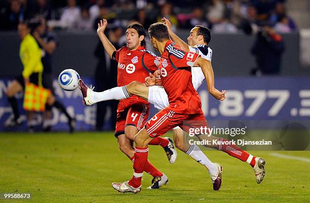 Landon Donovan of the Los Angeles Galaxy is sandwiched in between Nick Garcia and Adrian Cann of Toronto FC during the second half action of the MLS...