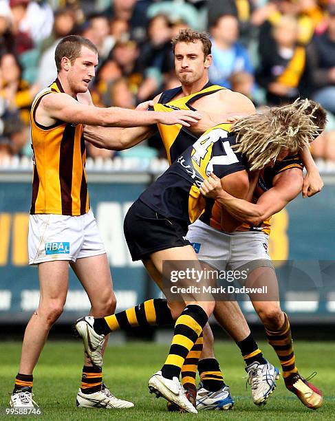 Ben Nason of the Tigers wrestles with Sam Mitchell of the Hawks during the round eight AFL match between the Richmond Tigers and the Hawthorn Hawks...