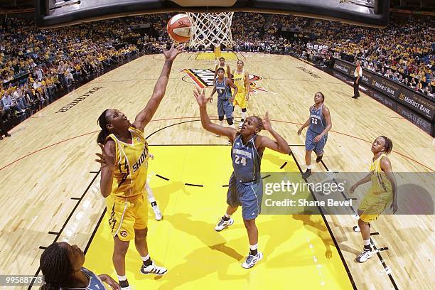 Charde Houston of the Minnesota Lynx watches as Kara Braxton of the Tulsa Shock pulls down a rebound during the WNBA game on May 15, 2010 at the BOK...