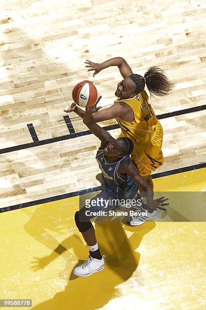 Hamchetou Maiga-Ba of the Minnesota Lynx reaches for a rebound over the top of Amber Holt of the Tulsa Shock during the WNBA game on May 15, 2010 at...