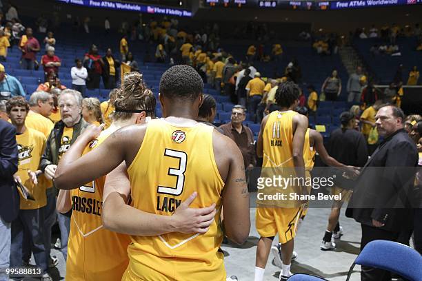 Shanna Crossley and Natasha Lacy of the Tulsa Shock leave the court after losing their opening game the Minnesota Lynx during the WNBA game on May...