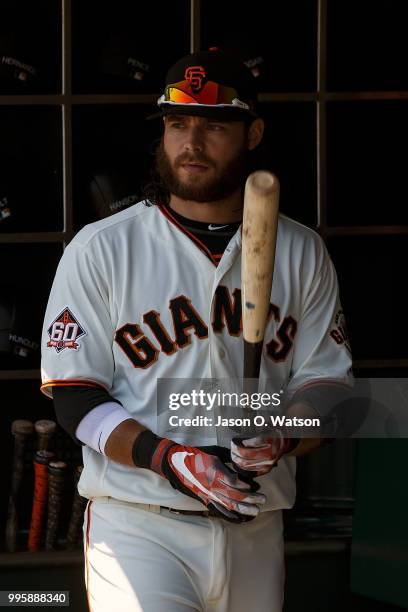 Brandon Crawford of the San Francisco Giants stands in the dugout before the game against the St. Louis Cardinals at AT&T Park on July 8, 2018 in San...