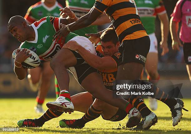 Eddy Pettybourne of the Rabbitohs is tackled during the round ten NRL match between the Wests Tigers and the South Sydney Rabbitohs at Sydney Cricket...