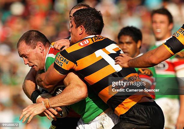 Luke Stuart of the Rabbitohs is tackled during the round ten NRL match between the Wests Tigers and the South Sydney Rabbitohs at Sydney Cricket...