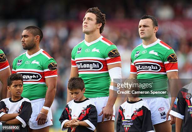 Sam Burgess of the Rabbitohs and team mates line up for the national anthem during the round ten NRL match between the Wests Tigers and the South...