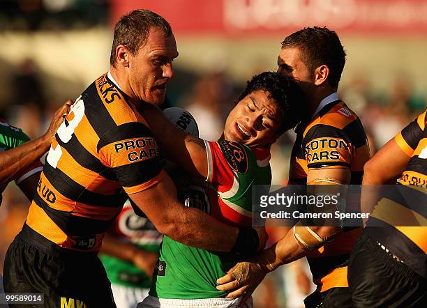 Issac Luke of the Rabbitohs is tackled during the round ten NRL match between the Wests Tigers and the South Sydney Rabbitohs at Sydney Cricket...