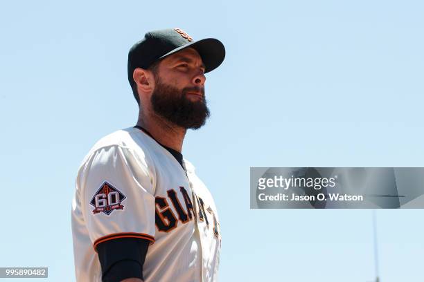 Brandon Belt of the San Francisco Giants stands outside the dugout before the game against the St. Louis Cardinals at AT&T Park on July 8, 2018 in...