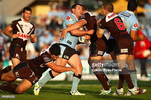Paul Gallen of the Sharks is tackled during the round ten NRL match between the Cronulla Sharks and the Penrith Panthers at Toyota Stadium on May 16,...