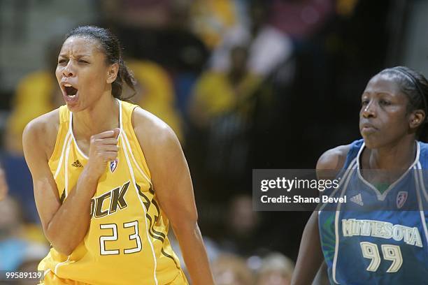 Hamchetou Magia-Ba of the Minnesota Lynx watches on as Plenette Pierson of the Tulsa Shock celebrates during the WNBA game on May 15, 2010 at the BOK...