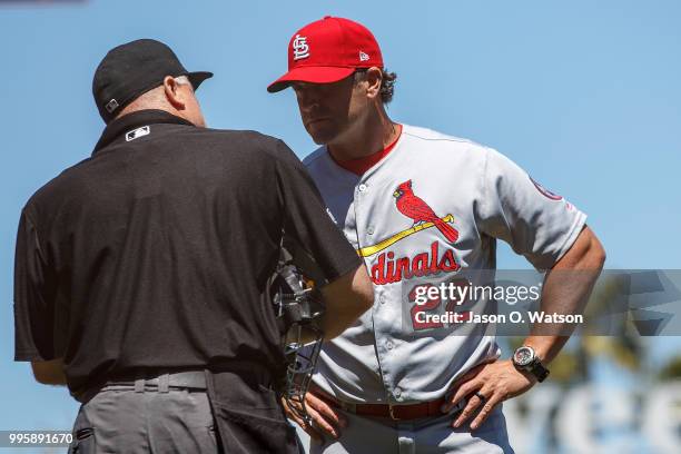 Mike Matheny of the St. Louis Cardinals talks to umpire Brian O'Nora after making a pitching change during the third inning against the San Francisco...