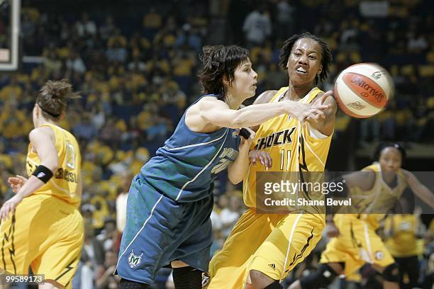 Nuria Martinez of the Minnesota Lynx makes a pass just out of the reach of Chante Black of the Tulsa Shock during the WNBA game on May 15, 2010 at...