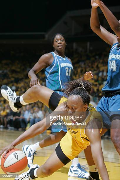 Amber Holt of the Tulsa Shock loses her footing while driving to the basket during the WNBA game on May 15, 2010 at the BOK Center in Tulsa,...