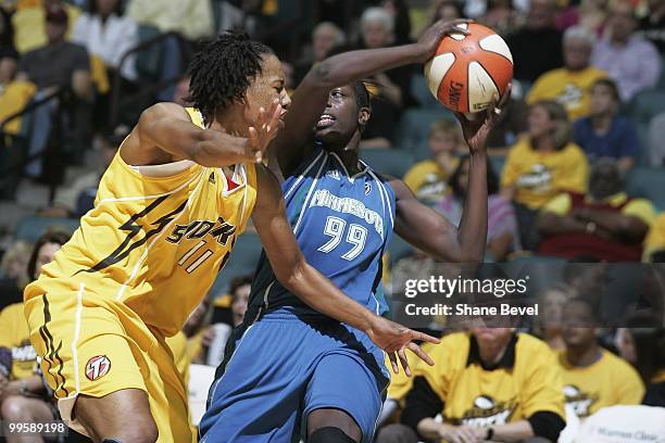 Hamchetou Maiga-Ba of the Minnesota Lynx struggles to keep the ball out of the hands of Chante Black of the Tulsa Shock during the WNBA game on May...