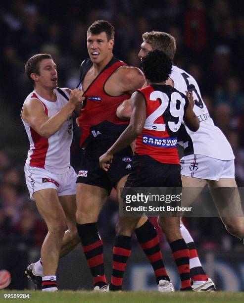 Saints players tussle with David Hille of the Bombers during the round eight AFL match between the St Kilda Saints and the Essendon Bombers at Etihad...