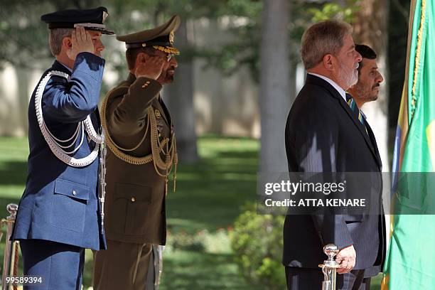 Iranian President Mahmoud Ahmadinejad and his Brazilian counterpart Luiz Inacio Lula da Silva listen to their countries' national anthems during a...