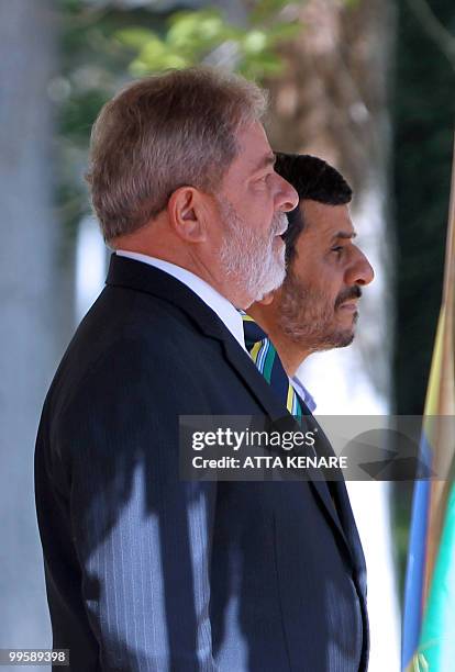 Iranian President Mahmoud Ahmadinejad and his Brazilian counterpart Luiz Inacio Lula da Silva listen to their countries' national anthems during a...