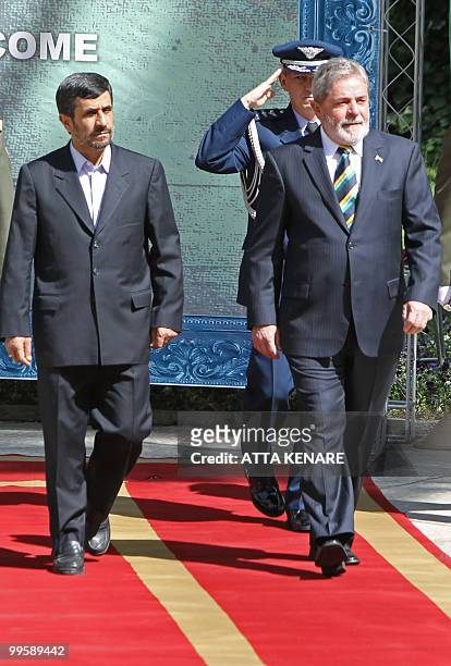 Iranian President Mahmoud Ahmadinejad and his Brazilian counterpart Luiz Inacio Lula da Silva review an honour guard during a welcoming ceremony for...