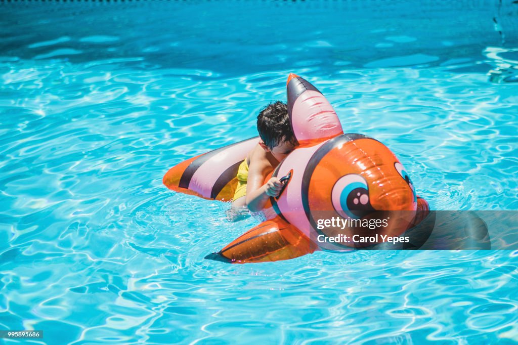 Boy Floating In In Pineaple Red Fish Inflatable Ringpool High-Res