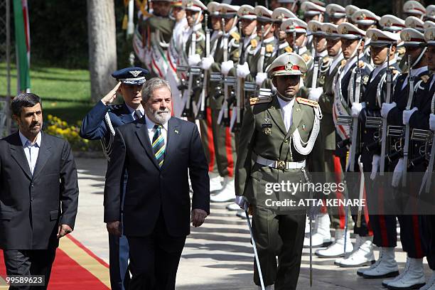 Iranian President Mahmoud Ahmadinejad and his Brazilian counterpart Luiz Inacio Lula da Silva review an honour guard during a welcoming ceremony for...