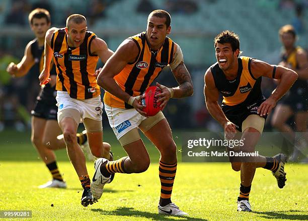 Lance Franklin of the Hawks takes a bounce as he runs the ball out of the back line during the round eight AFL match between the Richmond Tigers and...