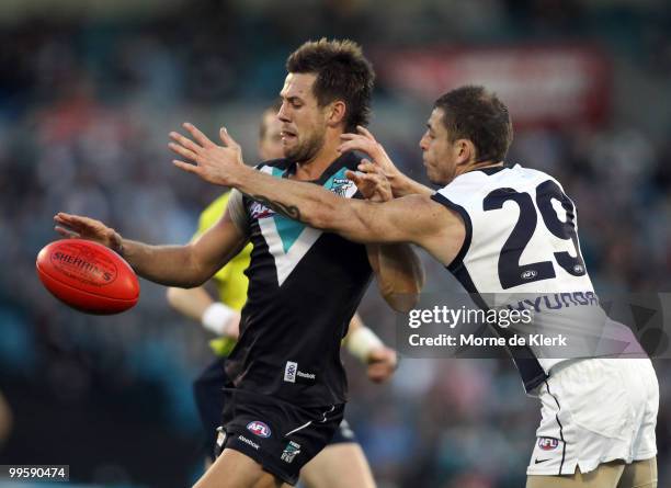 Steven Salopek of the Power is put under pressure by Heath Scotland of the Blues during the round eight AFL match between the Port Adelaide Power and...