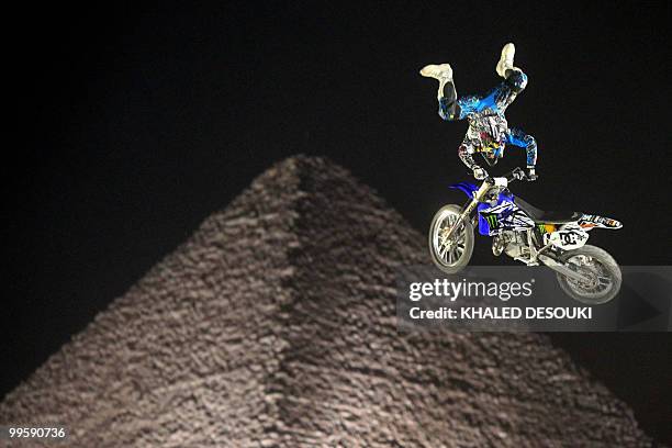 Freestyle biker jumps in front of the Giza pyramids during the second stage of the freestyle motocross Red Bull X-Fighters World Tour on the...