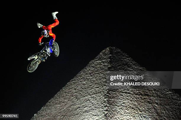 Freestyle biker jumps in front of the Giza pyramids during the second stage of the freestyle motocross Red Bull X-Fighters World Tour on the...