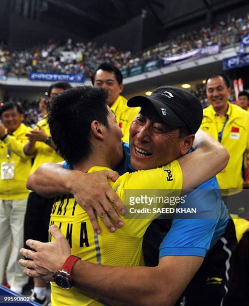 China's team official Li Yongo hugs winning player Cai Yun as they celebrate their victory over Indonesia's Markis Kido And Hendra Setiawan in the...
