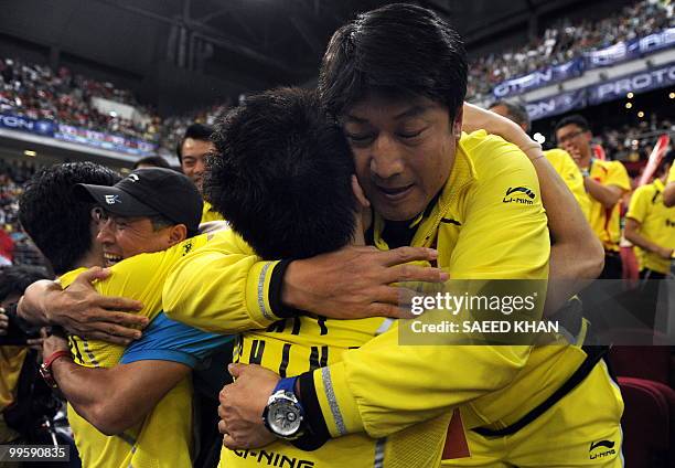 China's team officials hug their winning players Cai Yun and Fu Haifeng as they celebrate their victory over Indonesia's Markis Kido And Hendra...