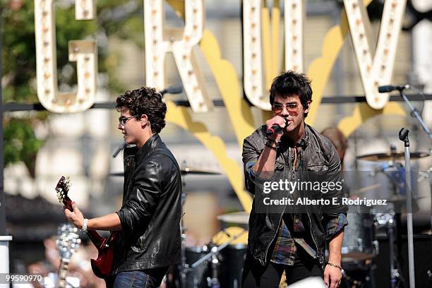 Musician Nick Jonas and musician Joe Jonas perform live at the Grove to kick off the summer concert series on May 15, 2010 in Los Angeles, California.