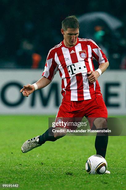 Bastian Schweinsteiger runs with the ball during the DFB Cup final match between SV Werder Bremen and FC Bayern Muenchen at Olympic Stadium on May...